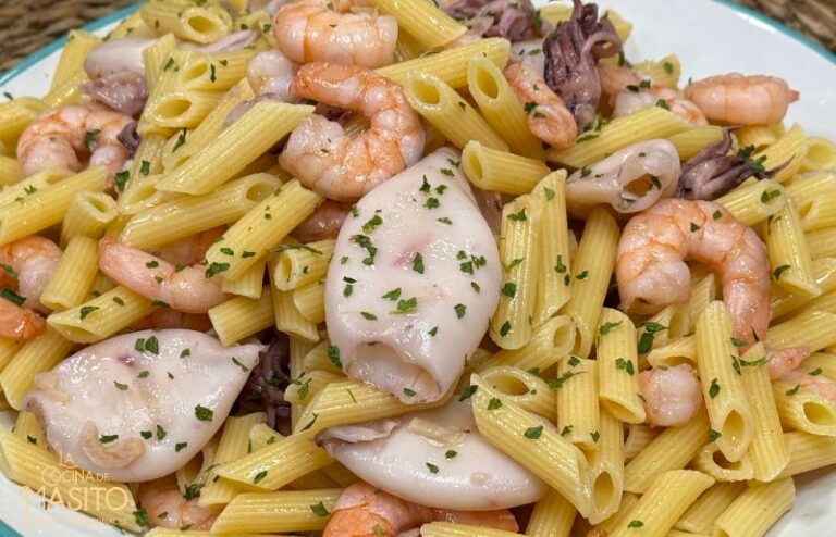 Plato de macarrones con calamares y langostinos al ajillo en salsa dorada con ajo y perejil