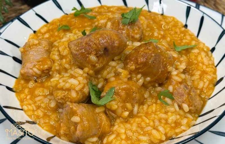 Arroz meloso de butifarra servido recién hecho con una textura cremosa.